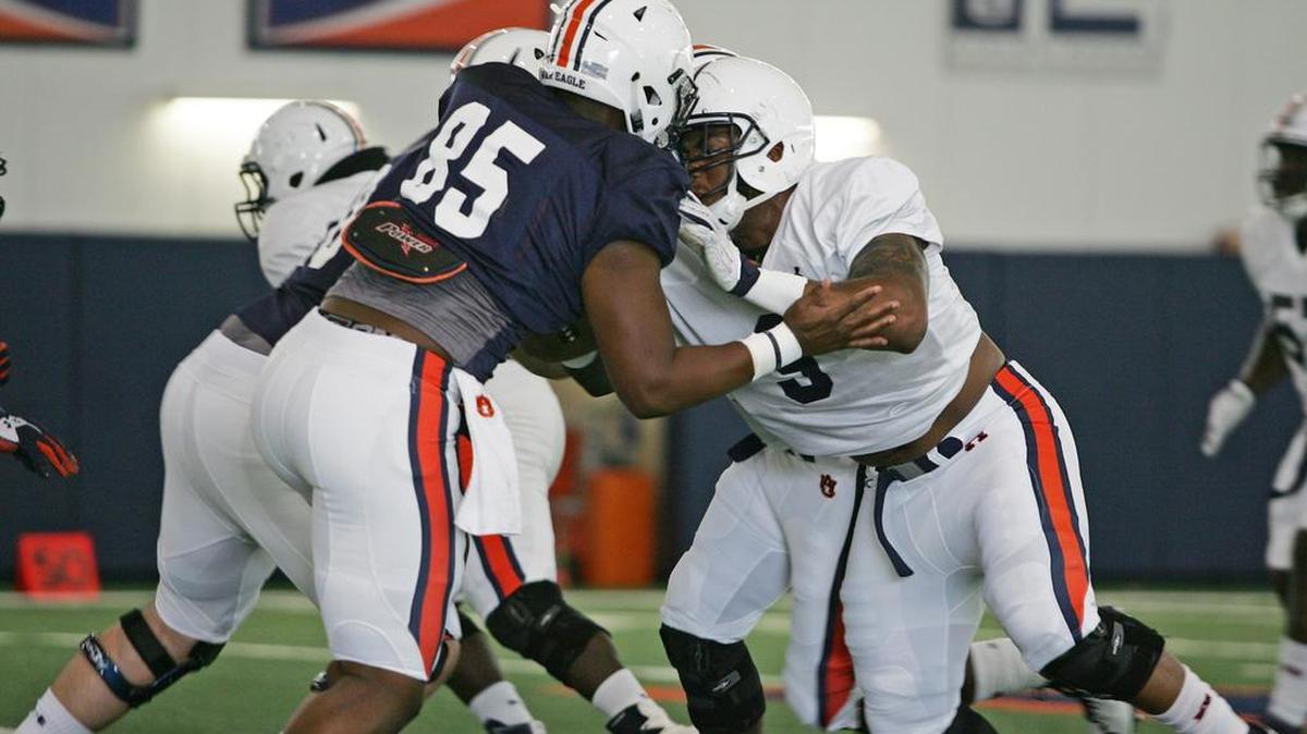 Auburn defensive lineman Bryon Cowart, No. 9, goes against Jalen Harris in training camp on Sunday, Aug. 7, 2016.