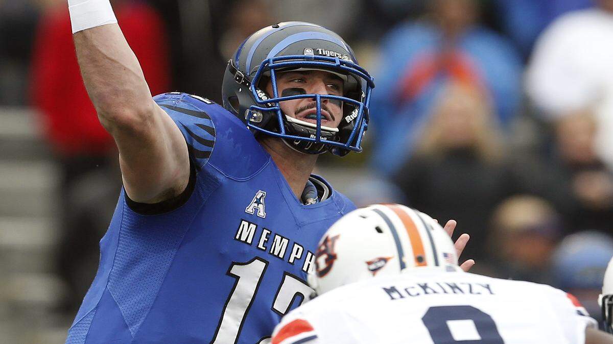 Memphis quarterback Paxton Lynch (12) throws a pass as Auburn linebacker Cassanova McKinzy (8) pressures him during the first half of the Birmingham Bowl NCAA college football game, Wednesday, Dec. 30, 2015, in Birmingham, Ala. (Butch Dill | AP Photo)