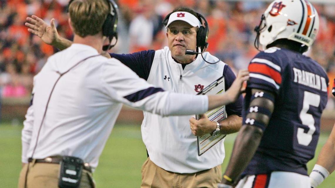 Auburn coach Gus Malzahn and Rhett Lashlee have a discussion on the sidelines facing Texas A&M Saturday, Sept. 17, 2016.