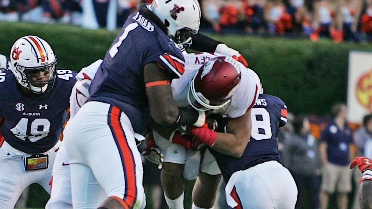 Auburn’s Montravius Adams (1) and Tray Matthews (28) tackle Arkansas’ Devwah Whaley during Saturday’s game.