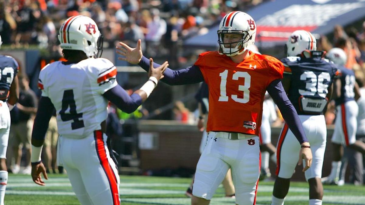 Auburn quarterback Sean White, No. 13, greets wide receiver Jason Smith before A-Day on April 9, 2016.