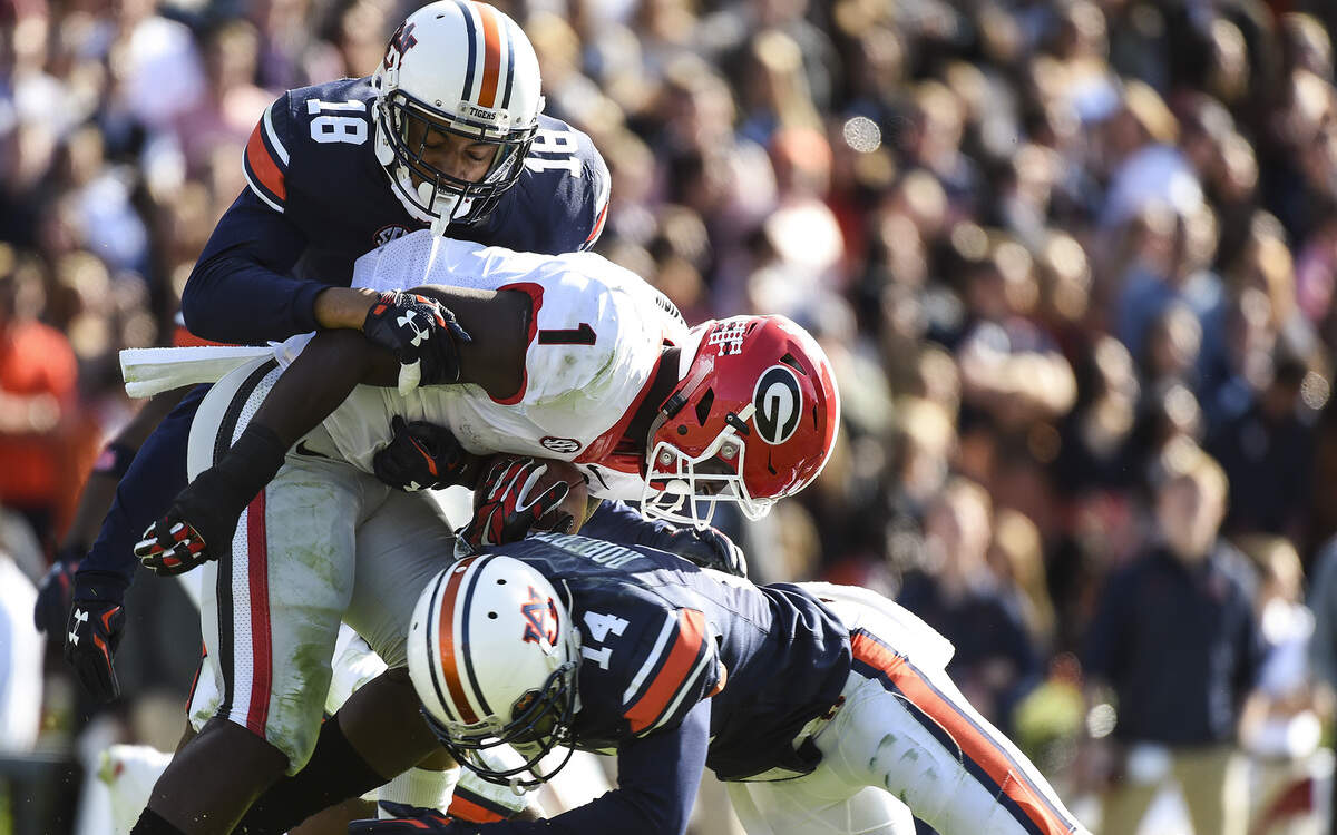 Auburn safety Stephen Roberts (14) and defensive back Carlton Davis (18) converge for a tackle against Georgia on Saturday, Nov. 14, 2015. (Zach Bland/Auburn Athletics)