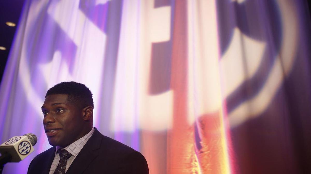 Auburn defensive lineman Carl Lawson speaks to reporters at the Southeastern Conference media days on Monday in Hoover, Ala.