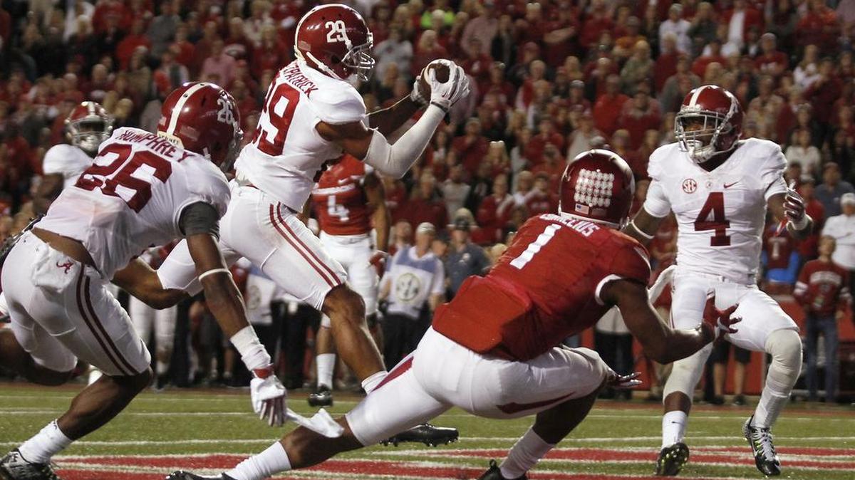 Alabama’s Minkah Fitzpatrick (29) intercepts a pass intended for Arkansas’ Jared Cornelius (1) in the Arkansas end zone during the fourth quarter Saturday in Fayetteville, Ark. Alabama won 49-30.