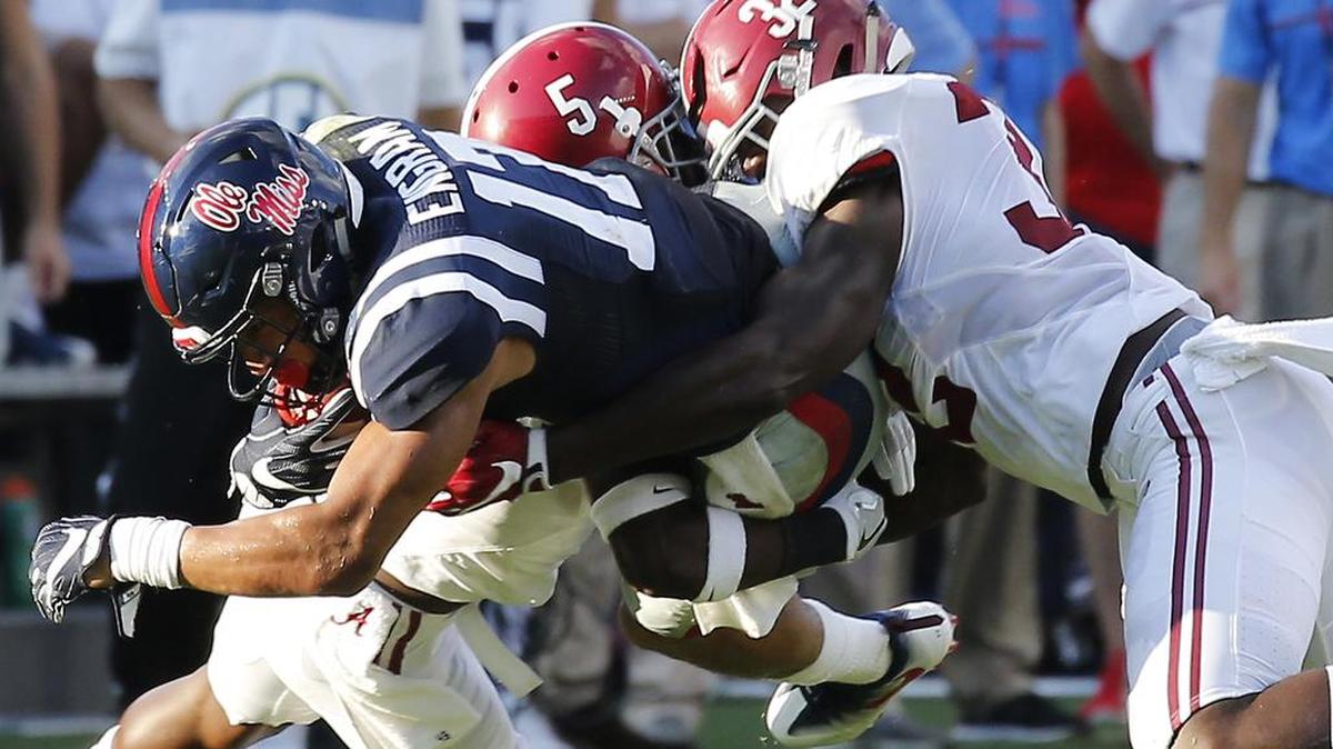 In this Sept. 17 file photo, Mississippi tight end Evan Engram (17) is tackled by Alabama defensive back Shyheim Carter (5) and linebacker Rashaan Evans (32) following a pass reception in the second half in Oxford, Miss.