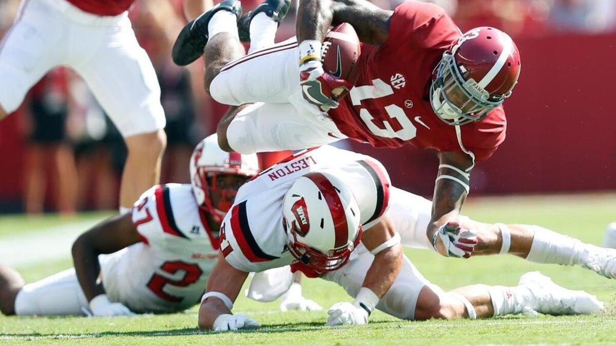Western Kentucky defensive back Branden Leston, tackles Alabama wide receiver ArDarius Stewart during the first half of an NCAA college football game, Saturday, Sept. 10, 2016, in Tuscaloosa, Ala. Alabama won 38-10. (AP Photo/Brynn Anderson)