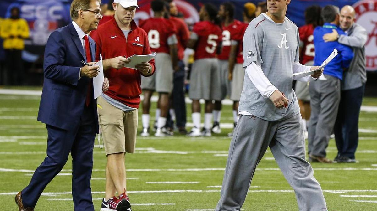 Alabama head coach Nick Saban, left, talks with Alabama offensive coordinator Lane Kiffin, right, during practice for the Southeastern Conference Championship NCAA college football game where they will play Florida, Friday, Dec. 2, 2016, in Atlanta.
