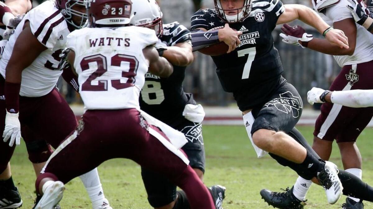 Mississippi State quarterback Nick Fitzgerald runs at Texas A&M defensive back Armani Watts (23) and other defenders during their game on Nov. 5.