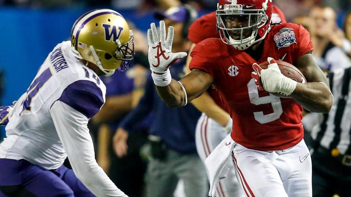 Alabama running back Bo Scarbrough stiff arms Washington defensive back Jojo McIntosh during the first half of the Peach Bowl on Dec. 31 in Atlanta.