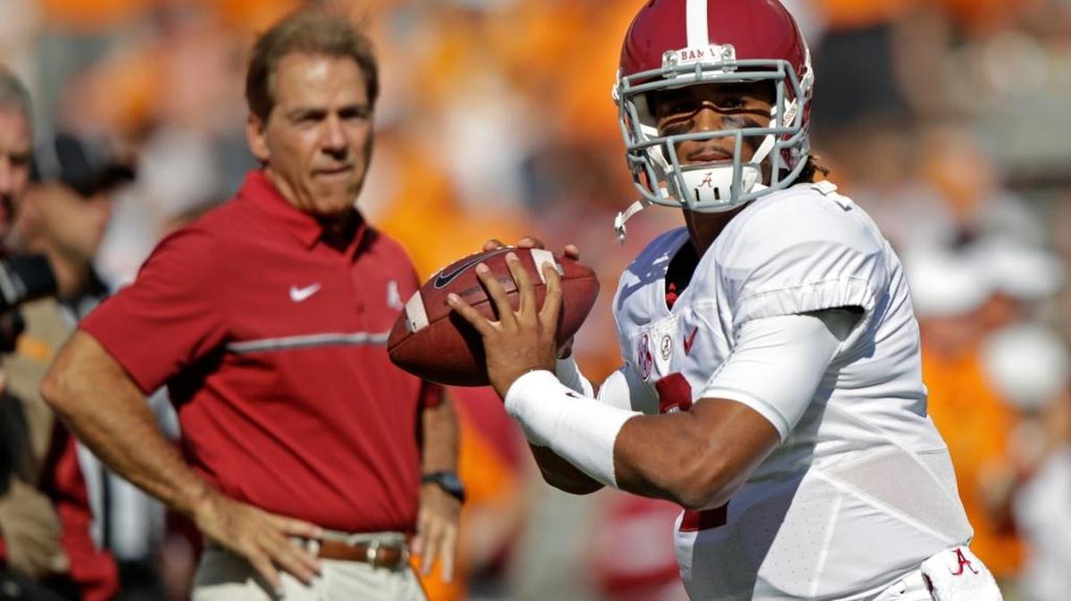 Alabama quarterback Jalen Hurts (2) warms up before an NCAA college football game against Tennessee as Alabama head coach Nick Saban watches on Oct. 15.