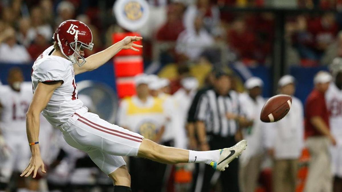 Alabama punter JK Scott kicks during the first half of the 2014 Southeastern Conference championship game in Atlanta.