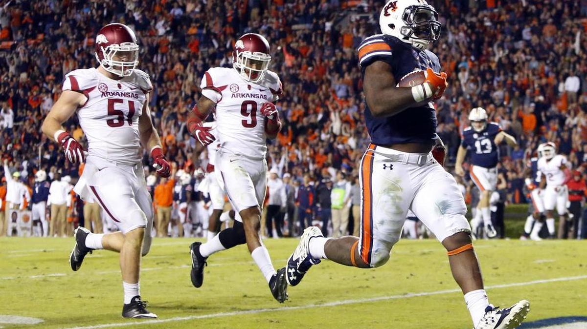 In this Oct. 22 file photo, Auburn running back Kamryn Pettway scores a touchdown as he beats Arkansas linebacker Brooks Ellis (51) and defensive back Santos Ramirez (9) to the end zone during the second half in Auburn, Ala.