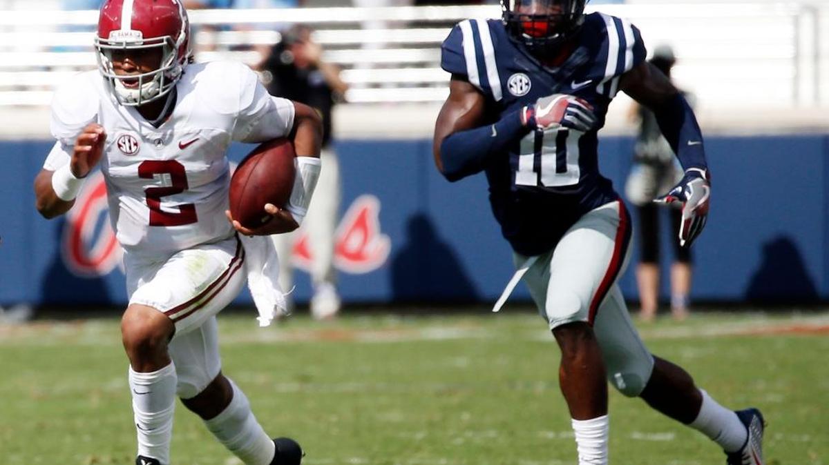 Alabama quarterback Jalen Hurts runs away from Mississippi defensive end Marquis Haynes in the first half Saturday.