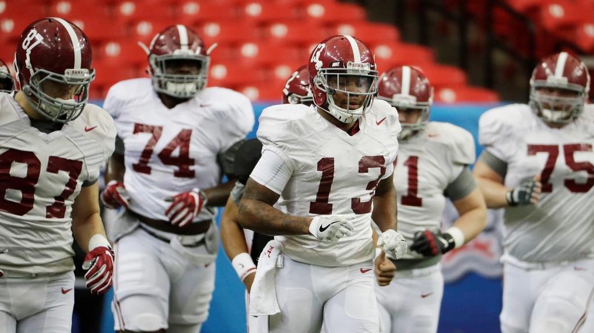 Alabama’s ArDarius Stewart (13) runs on the field with teammates during a Peach Bowl practice in Atlanta on Wednesday. Alabama and Washington will face off in the Peach Bowl football game Saturday.