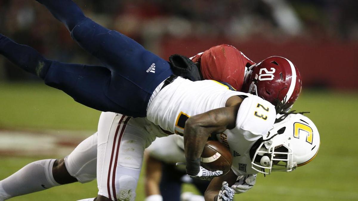Alabama linebacker Shaun Dion Hamilton tackles Chattanooga running back Richardre Bagley while diving for more yardage during the first half Saturday in Tuscaloosa, Ala.