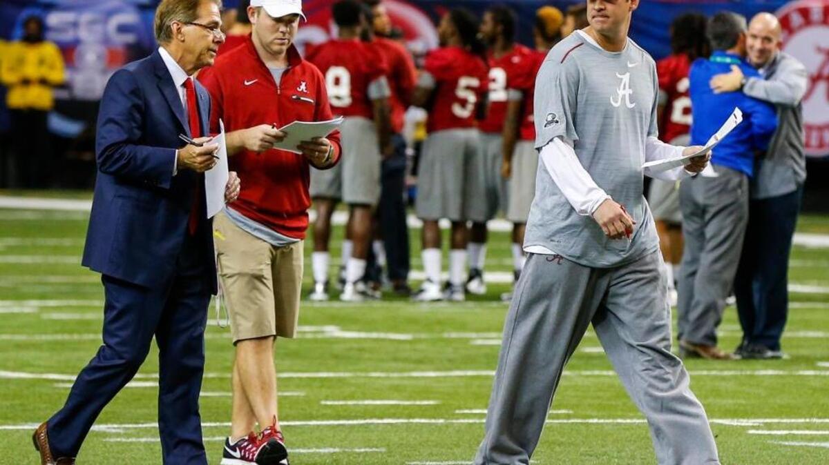Alabama head coach Nick Saban, left, talks with Alabama offensive coordinator Lane Kiffin, right, during practice for the SEC Championship.