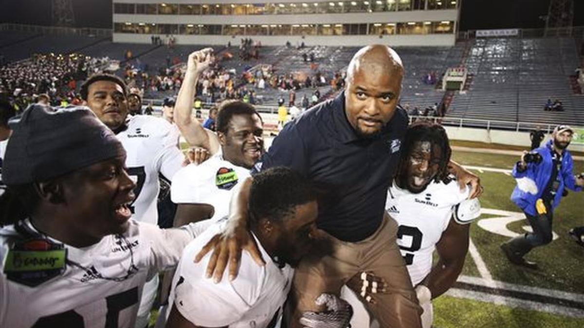 Georgia Southern players carry interim coach Dell McGee after the team's 58-27 win over Bowling Green in the GoDaddy Bowl NCAA college football game Wednesday, Dec. 23, 2015, in Mobile, Ala.