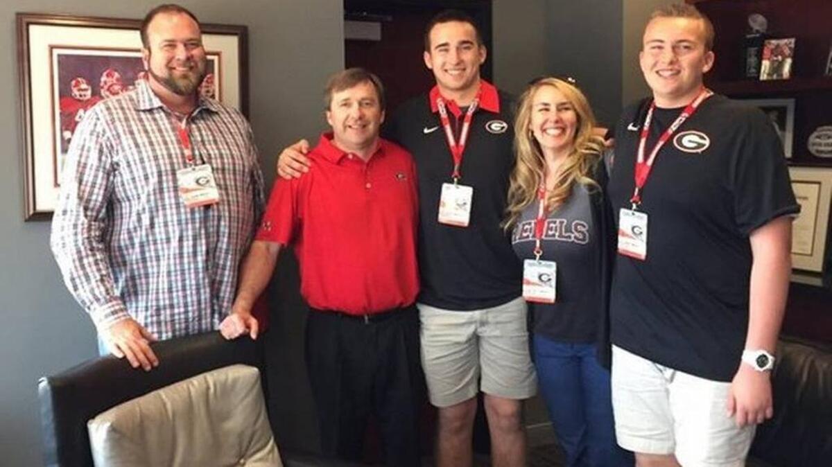 Max Wray and his family pose with Kirby Smart on a recruiting visit