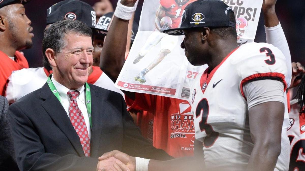 Georgia Athletic Director Greg McGarity congratulates Roquan Smith after the University of Georgia won the SEC Championship. Georgia beat Auburn 28-7.
