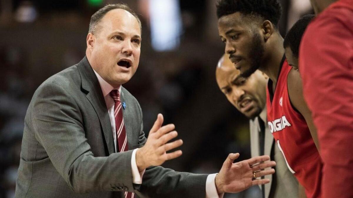 Georgia head coach Mark Fox communicates with players during the first half of an NCAA college basketball game against South Carolina.