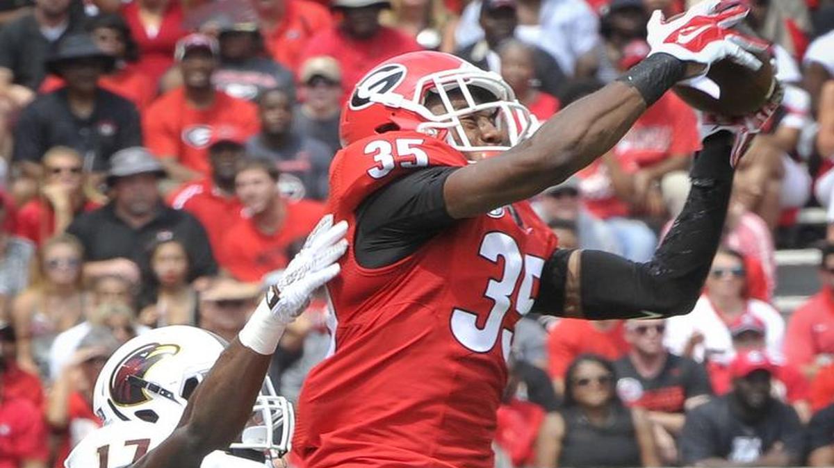 Georgia cornerback Aaron Davis catches an interception in front of Louisiana Monroe wide receiver RJ Turner during the first quarter Sept., 5, 2015, in Athens, Ga. Georgia won the game 51-14.