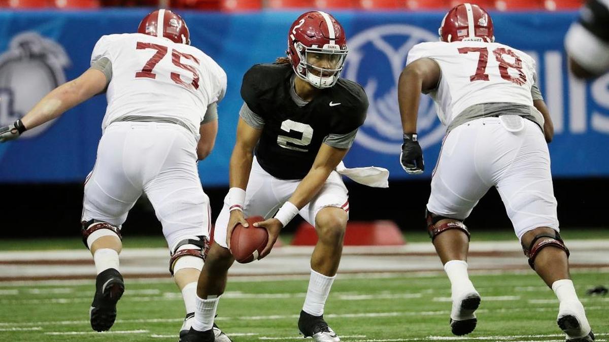 Alabama quarterback Jalen Hurts, center, runs a drill Wednesday during a Peach Bowl practice in Atlanta.