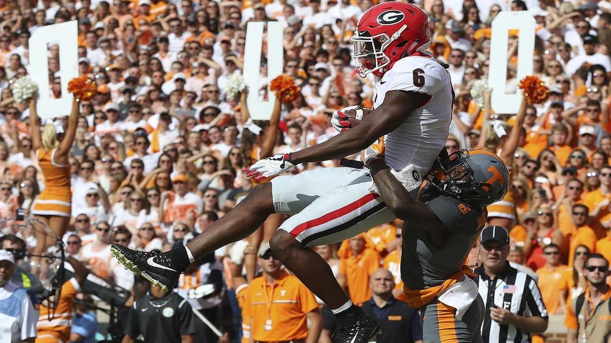 Georgia wide receiver Javon Wims catches a touchdown pass over Tennessee defensive back Shaq Wiggins during the first half an NCAA college football game against Tennessee on Saturday, Sept. 30, 2017, in Knoxville, Tenn. (Curtis Compton/Atlanta Journal-Constitution via AP)