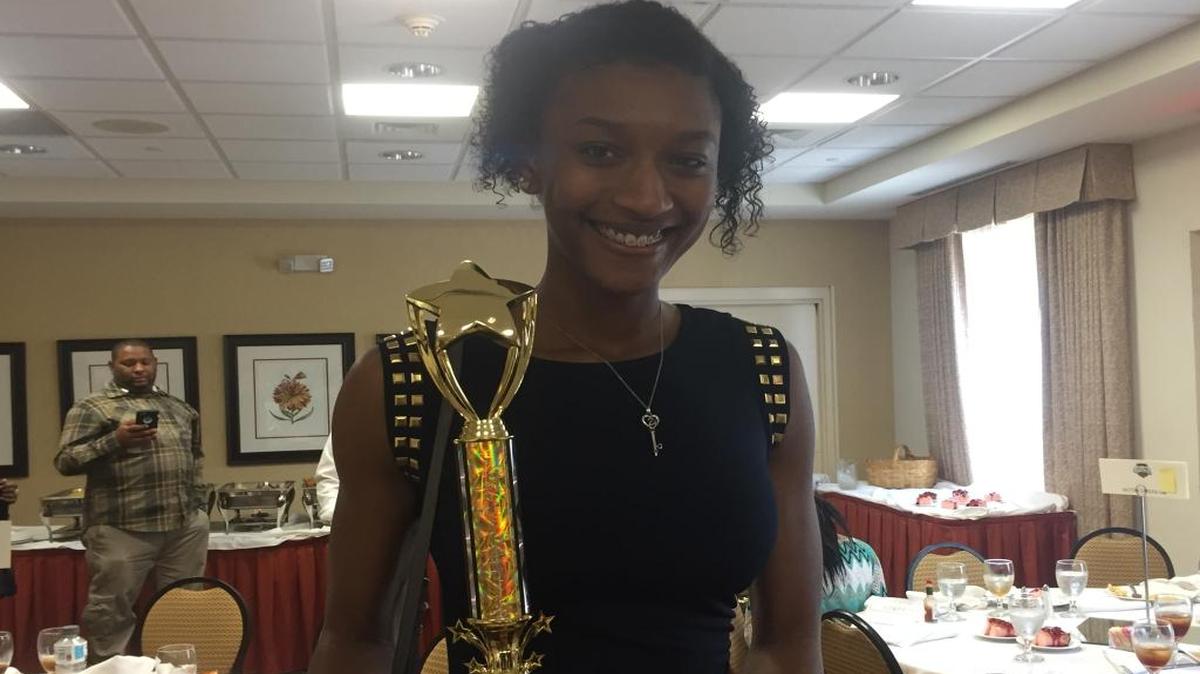 Columbus senior Tatyana Wyatt poses with her trophy after being selected as the Sue Walton Outstanding Athlete of the Year Award on April 20, 2017.