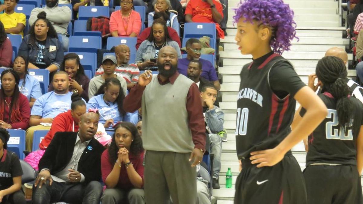Carver head coach Anson Hundley (standing) has a lot of talent on his 2017-2018 team, including guard Mariah Igus (10)