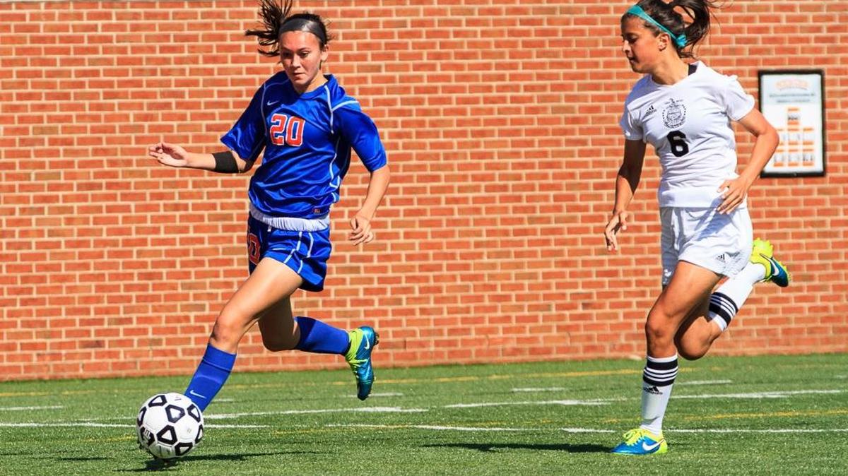 Columbus’ Kimberly May (20) gets around McIntosh’s Caroline Chang (6) in the GHSA Class 5A soccer championship game.