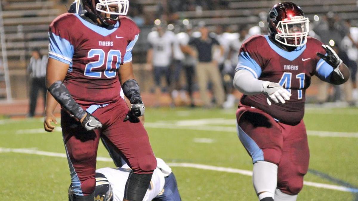 Carver’s Andrew Ogletree, left, and Lyndon Johnson keep Douglas County’s Uriah West out of the end zone. Johnson verbally committed to Shorter University on Monday.