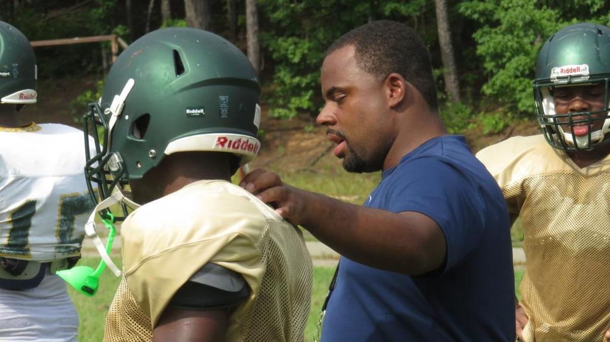 Spencer head coach Pierre Coffey works with his Greenwave offense as the team preps for the 2017 season.