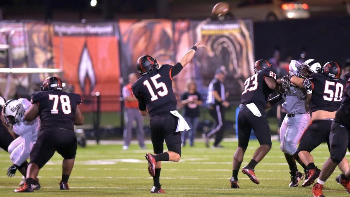 Central's Tucker Melton throwing a touch down pass to Derrick Moore in the end zone for their 6th touch down in the first half of the game against Smiths Station.