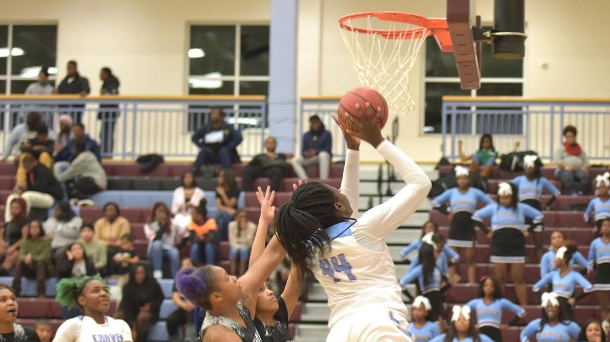 Carver's Olivia Cochran cuts around the Shaw defenders to the basket in the third period of the game against Shaw Friday night, December 15, 2017