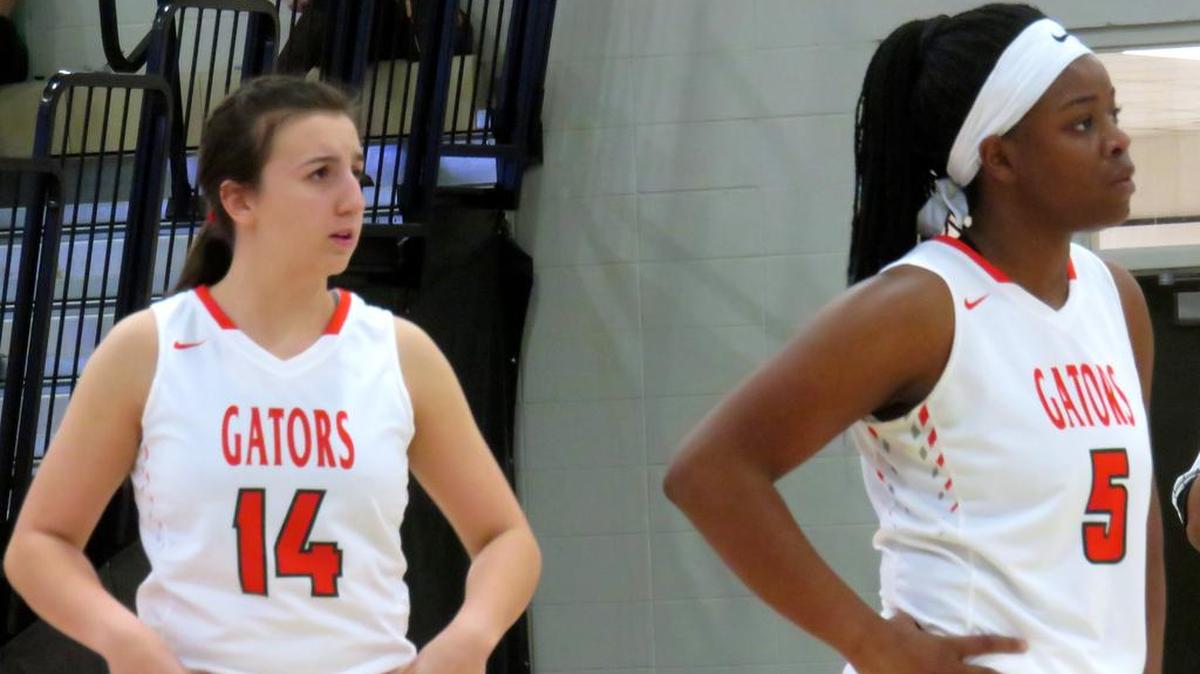 Glenwood’s Katie Suarez (14) and Quan Holton (5) prepare for an in-bound in Monday night’s AISA Class 3A state title game against Tuscaloosa Academy. The Lady Gators fought until the final buzzer but fell 27-25