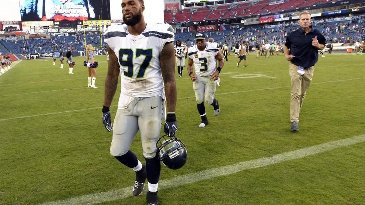 Seattle Seahawks defensive end Marcus Smith (97) and quarterback Russell Wilson (3) leave the field after an NFL football game against the Tennessee Titans Sunday, Sept. 24, 2017, in Nashville, Tenn. The Titans won 33-27