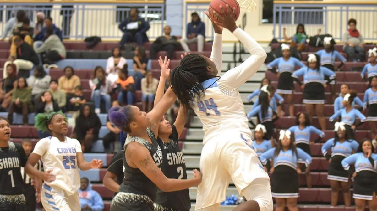 Carver's Olivia Cochran cuts around the Shaw defenders to the basket in the third period of the game against Shaw Friday night, December 15, 2017