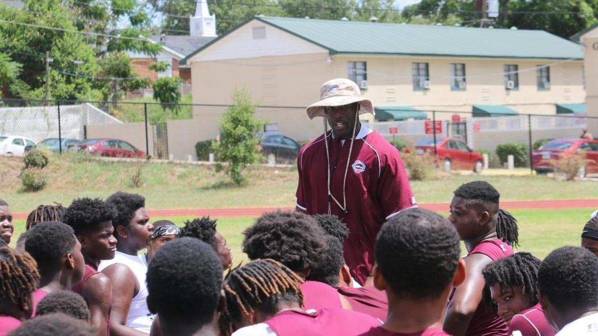 Dre’Mail King talks to the Carver High School football team during a practice this past summer.