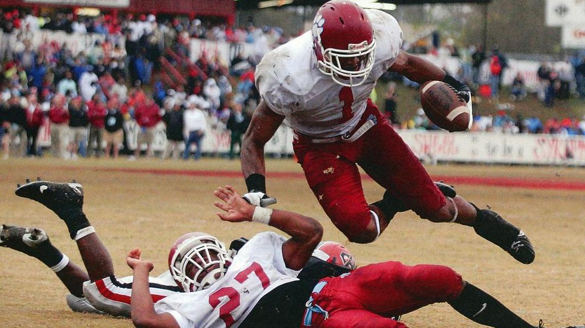 Senior wide receiver Jarmon Fortson hurdles over teammate Jarkius Morgan to score on a 1-yard run and give Carver a 9-0 halftime lead over Cairo in the 2007 state championship game.