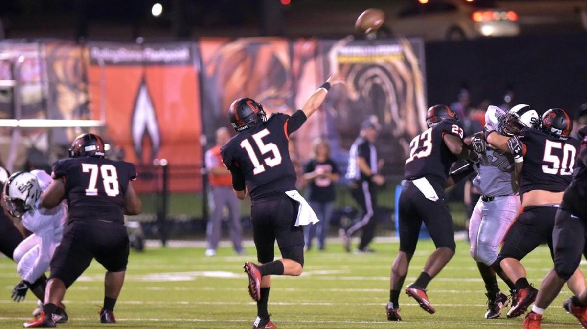 Central's Tucker Melton throws a touchdown pass to Derrick Moore in the first half of Friday’s game against Smiths Station. Central won 62-7.