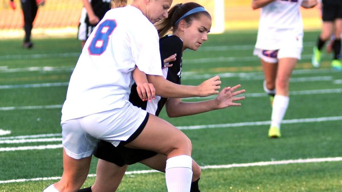 Columbus’ Sage Konans and Alexander’s Macey Hodge fight for the ball in the first half of the game Wednesday night at Kinnett Stadium.