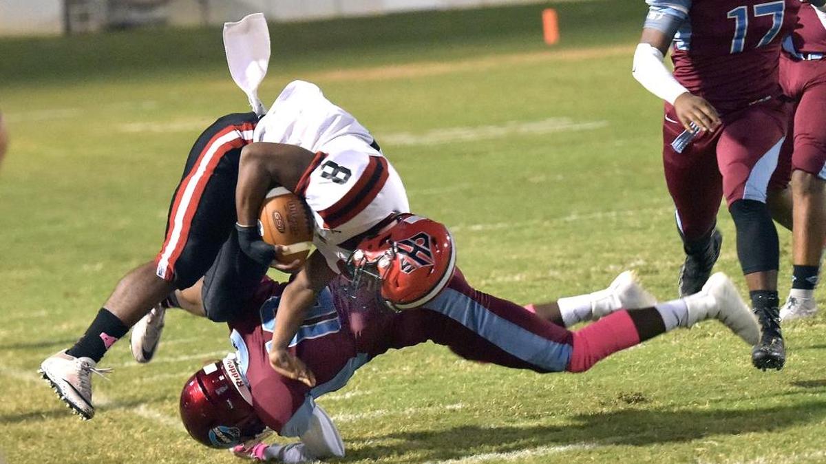 Carver's Joseph Jones drives Cairo's Quay Edwards to the sideline during Friday’s game.