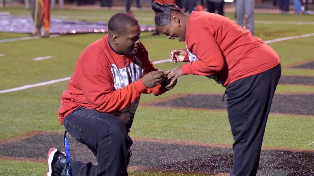 Bam Marcus surprises Cynthia Sanders in the end zone with an engagement ring before the start of the Central versus Lee-Montgomery Friday, November 17, 2017