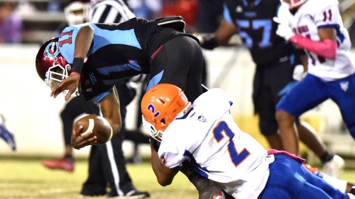 Carver's Xaiyhir Jacobs is tackled by Columbus' Mike Ramsey after scrambling out of the backfield for an 8-yard run and a first down in the closing minutes of the first half of Friday’s game.