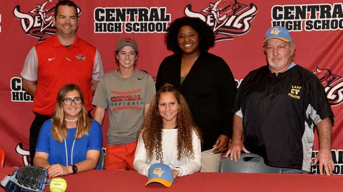 Gracie Deaton and Tatyana Harris posing for pictures with their Central High School coaches, Mitchell Holt, April Jowers,  Misha Aldridge, and Steve Osteen during their signing ceremony for Chattahoochee Valley Community College and The University of Alabama in Huntsville, Wednesday November 8, 2017