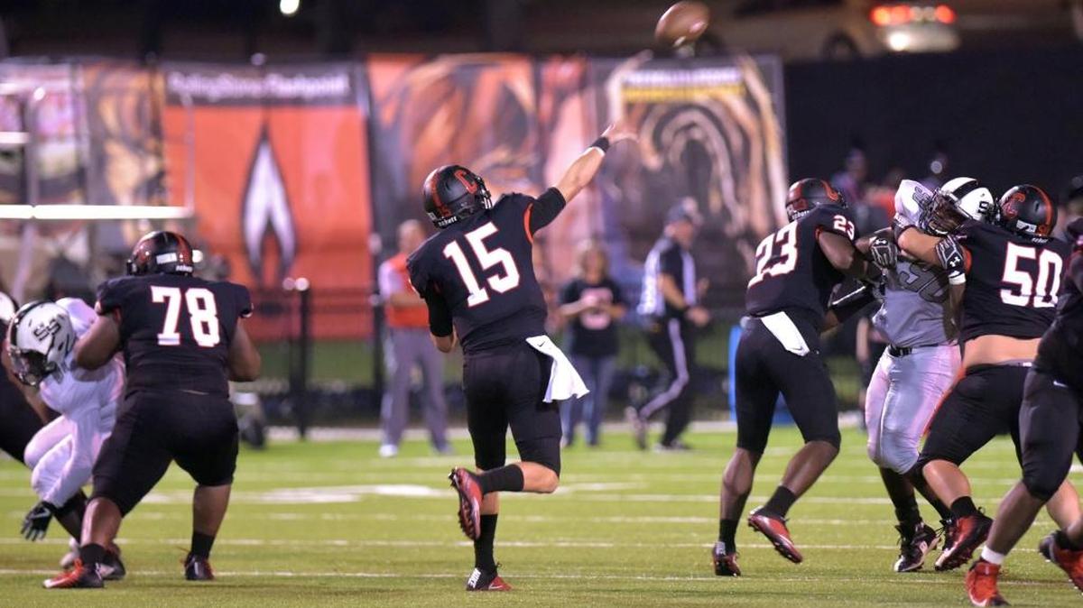 Central's Tucker Melton throws a touchdown pass to Derrick Moore in the end zone for the Red Devils’ sixth touchdown in the first half against Smiths Station Friday, September 22, 2017