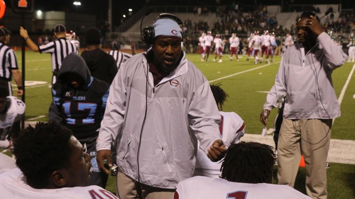 Carver defensive coordinator Calvin Arnold talks with the Tigers during Friday night’s game.