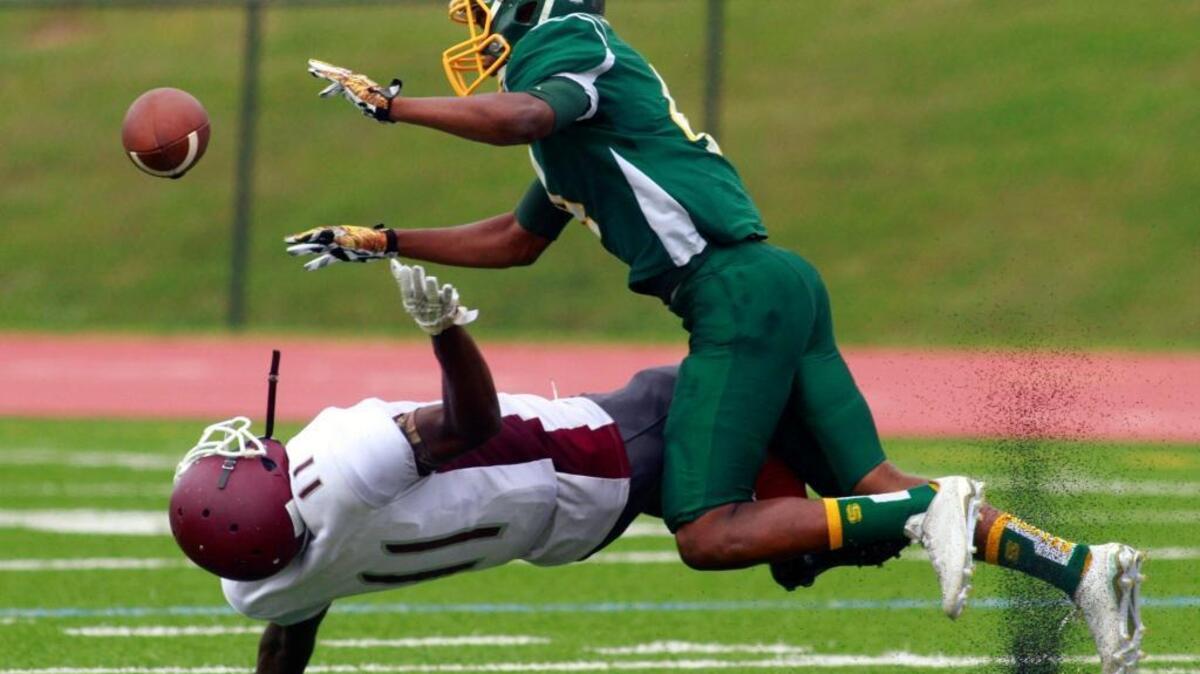 Spencer’s Travell Jones, top, runs into Dougherty receiver Dre’shon Alston during a pass play in the first half Saturday morning at Kinnett Stadium in Columbus.