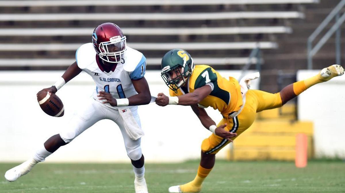 Spencer's Devonte Webster sacks Carver's Xaiyr Jacobs for a 10 yard loss in the first quarter of their game Friday at Memorial Stadium.