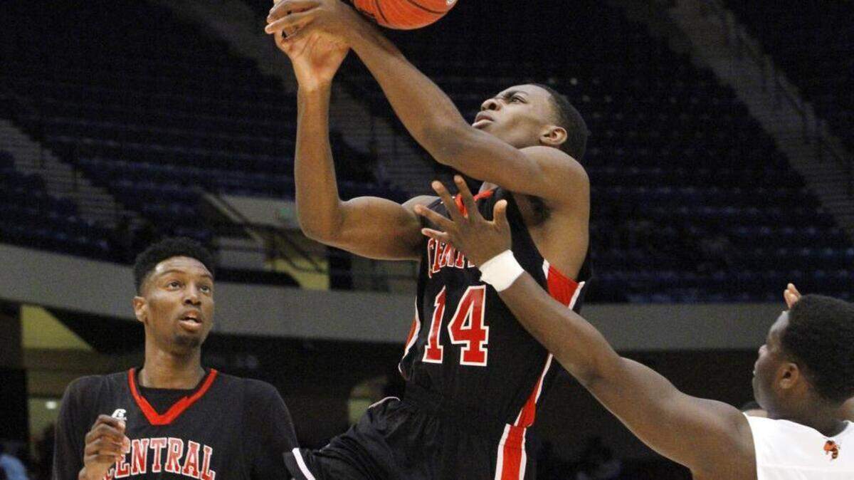 Mcgill-Toolen's Carlton Martial (22) blocks Central High guard Demarcus Lampley's shot in first half play in the AHSAA Class 7A final at Legacy Arena in Birmingham, Ala., Saturday.